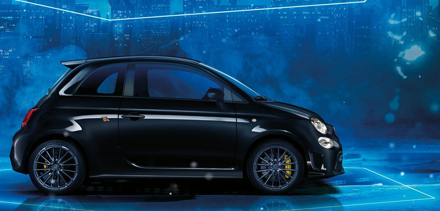 Abarth 695 compact car driving on a colourful background
