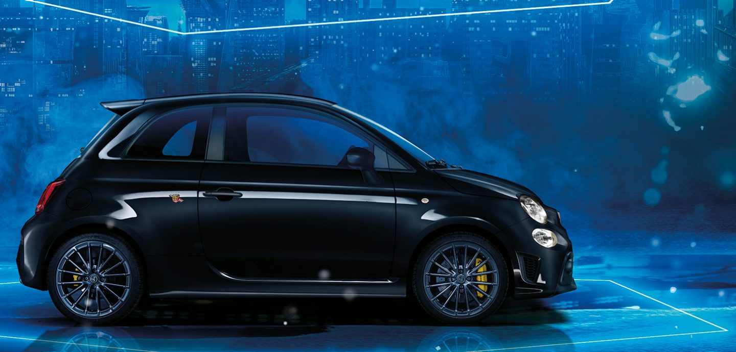 Abarth 695 compact car driving on a colourful background